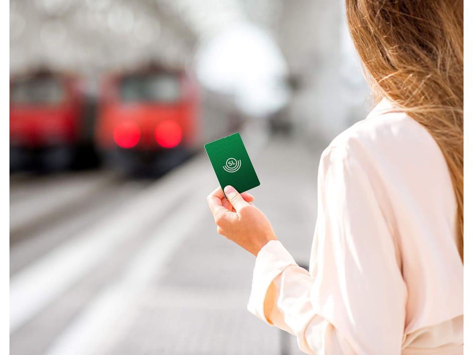 Woman holds up new SL closed-loop card based on white-label EMV.